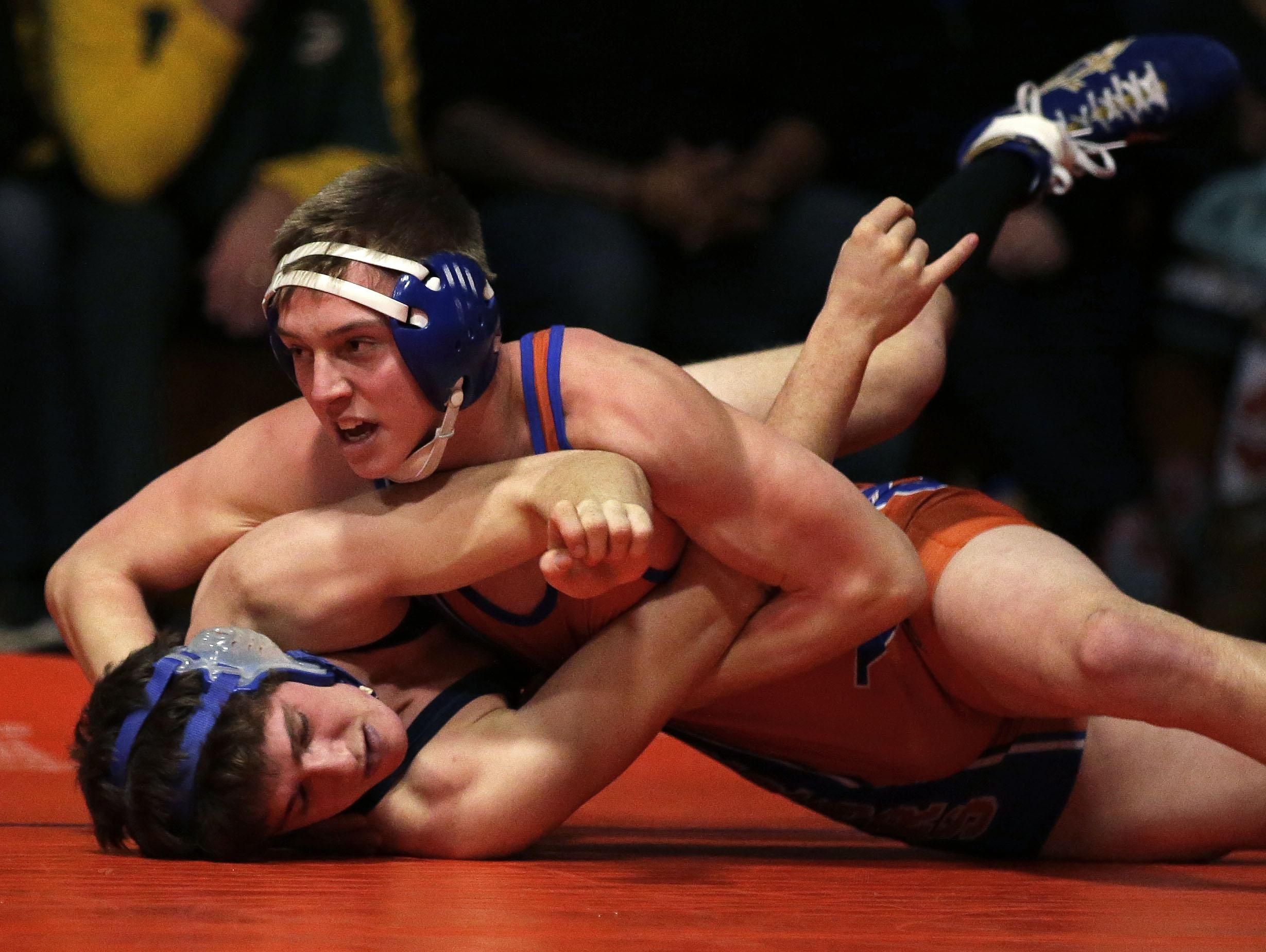James Meyer, top, of Appleton West wrestles Aaron Reiland of Appleton North at 152 pounds Thursday during a Fox Valley Association dual meet at West.