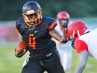 Cocoa High's QB Bruce Judson stiff arms a Lake Highland Prep defender as he turns the corner during a game held at Cocoa Stadium.