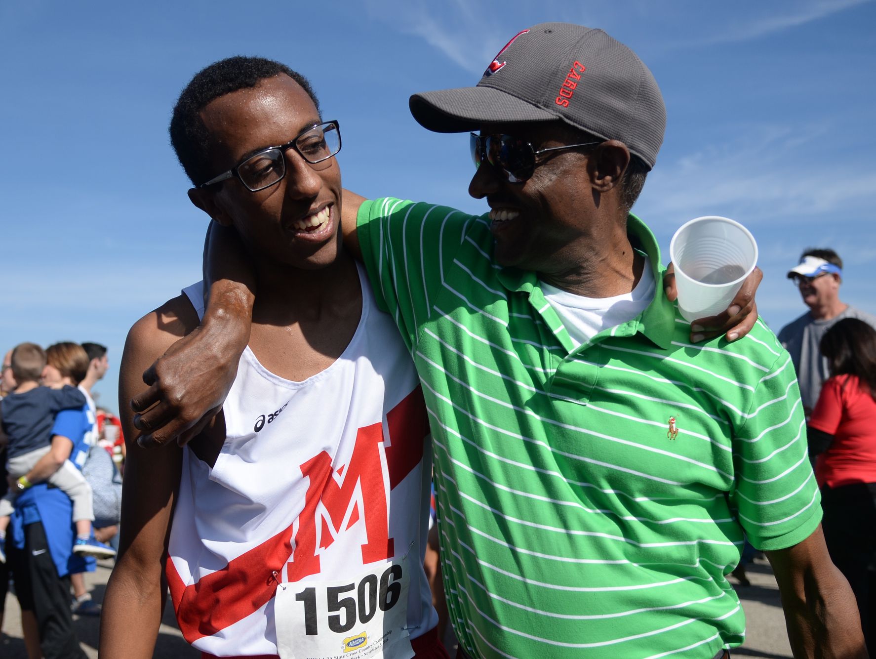 Dupont Manaul's Yared Nuguse hugs his father, Alem, after winning the KHSAA Class 3-A boys state cross country meet at the Kentucky Horse Park in Lexington, KY on Saturday, November 5, 2016.
