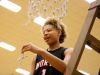 North Central sophomore Rikki Harris cuts off a piece of the net after the Panthers' sectional title win Saturday night.
