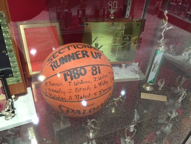 An awards display case commemorates a 1980-81 sectional runner-up finish.