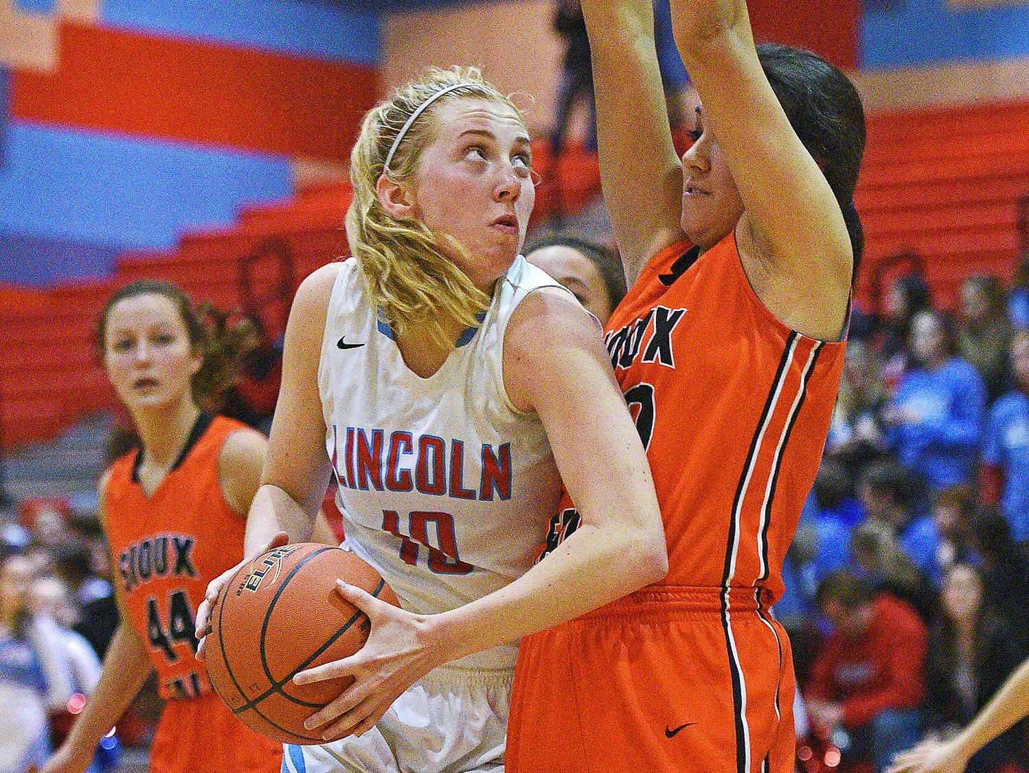 Lincoln's Anna Brecht (10) drives past Washington's Taylor VanderVelde (30) during a game Tuesday, Feb. 7, 2017, at Lincoln High School in Sioux Falls.