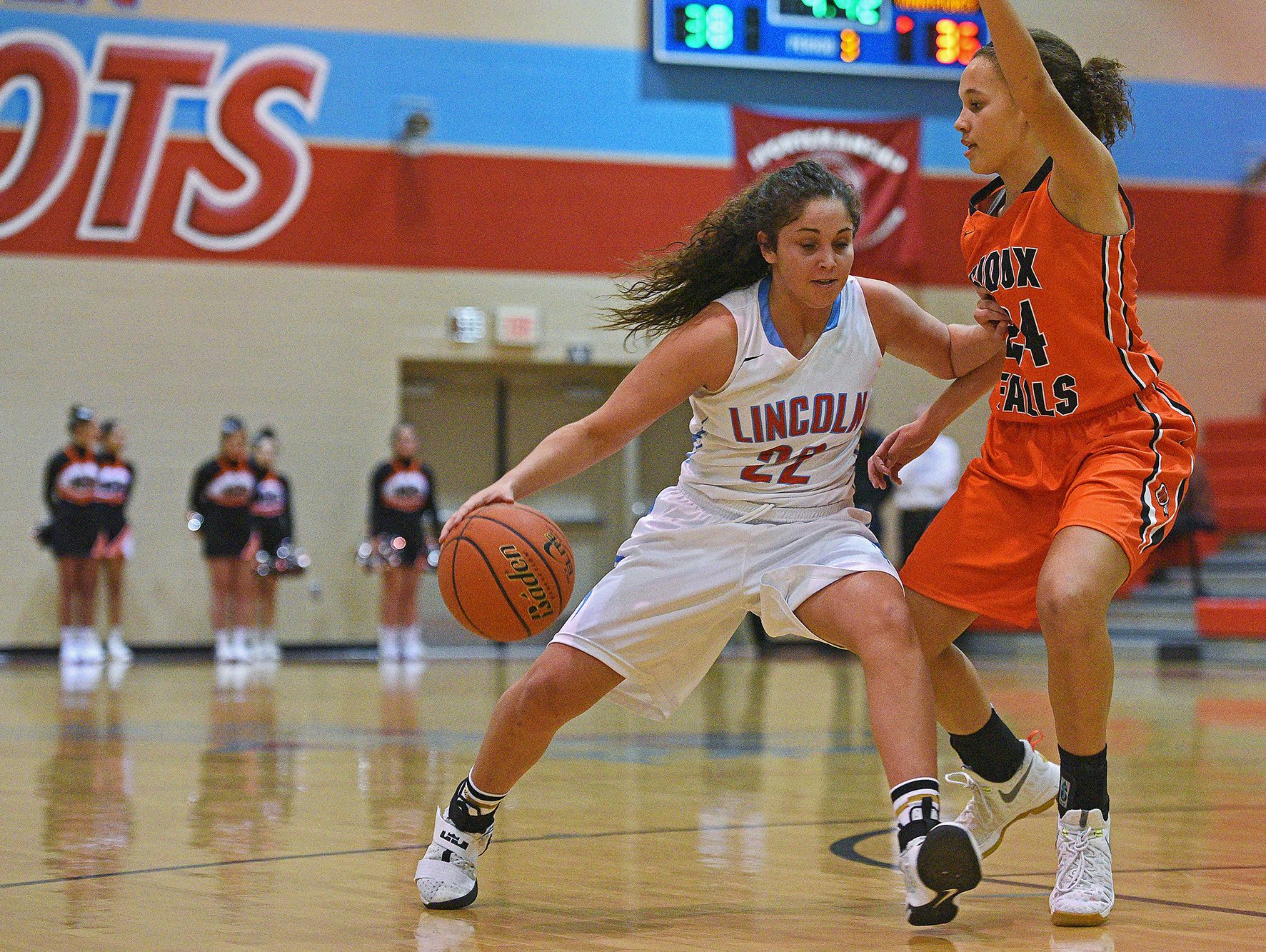 Lincoln's Sydney Rosinsky (22) tries to get by Washington's Jada Cunningham (24) during a game Tuesday, Feb. 7, 2017, at Lincoln High School in Sioux Falls.