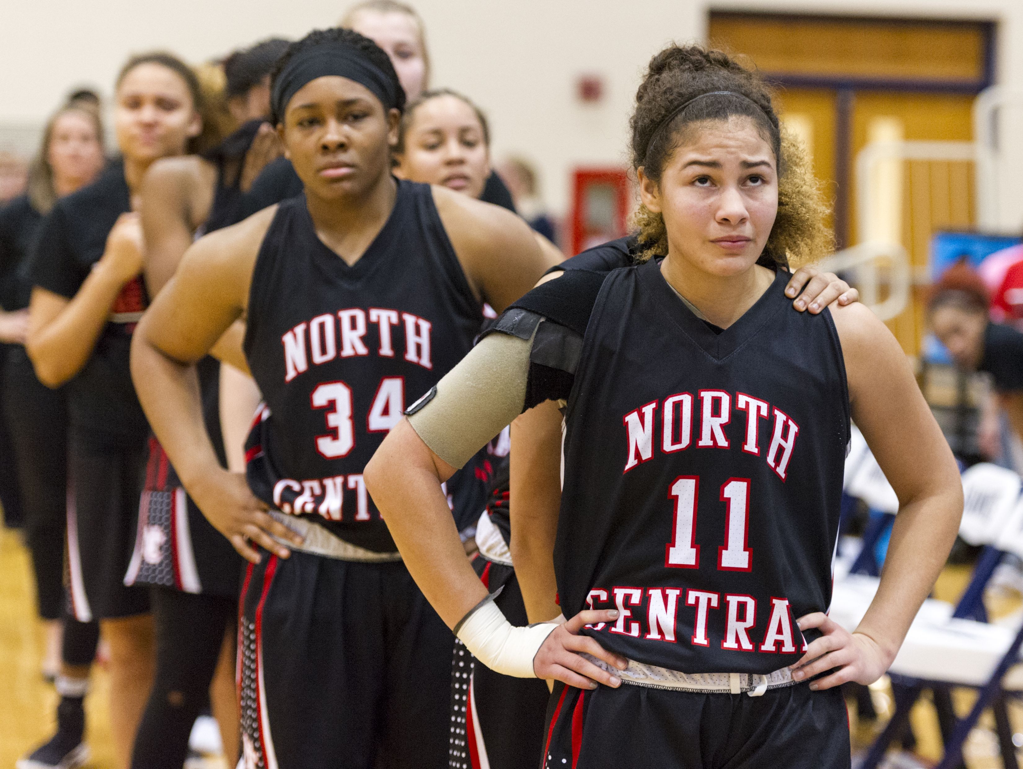North Central High School junior Taylor Ramey (11) and her teammates react to their loss of the IHSAA 4A Girls' Basketball Tournament Regional championship game, Saturday, Feb. 11, 2017, at Decatur Central High School. Pike won in overtime, 61-59.
