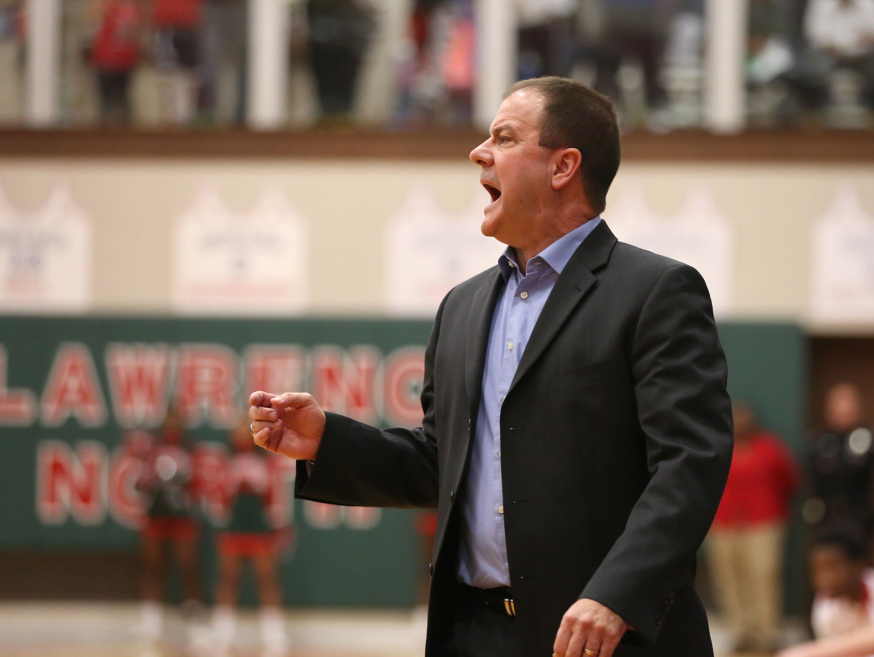FILE – Carmel coach Scott Heady calls out to his team against Lawrence North at Lawrence North Friday February 6, 2015. Carmel won 52-49.