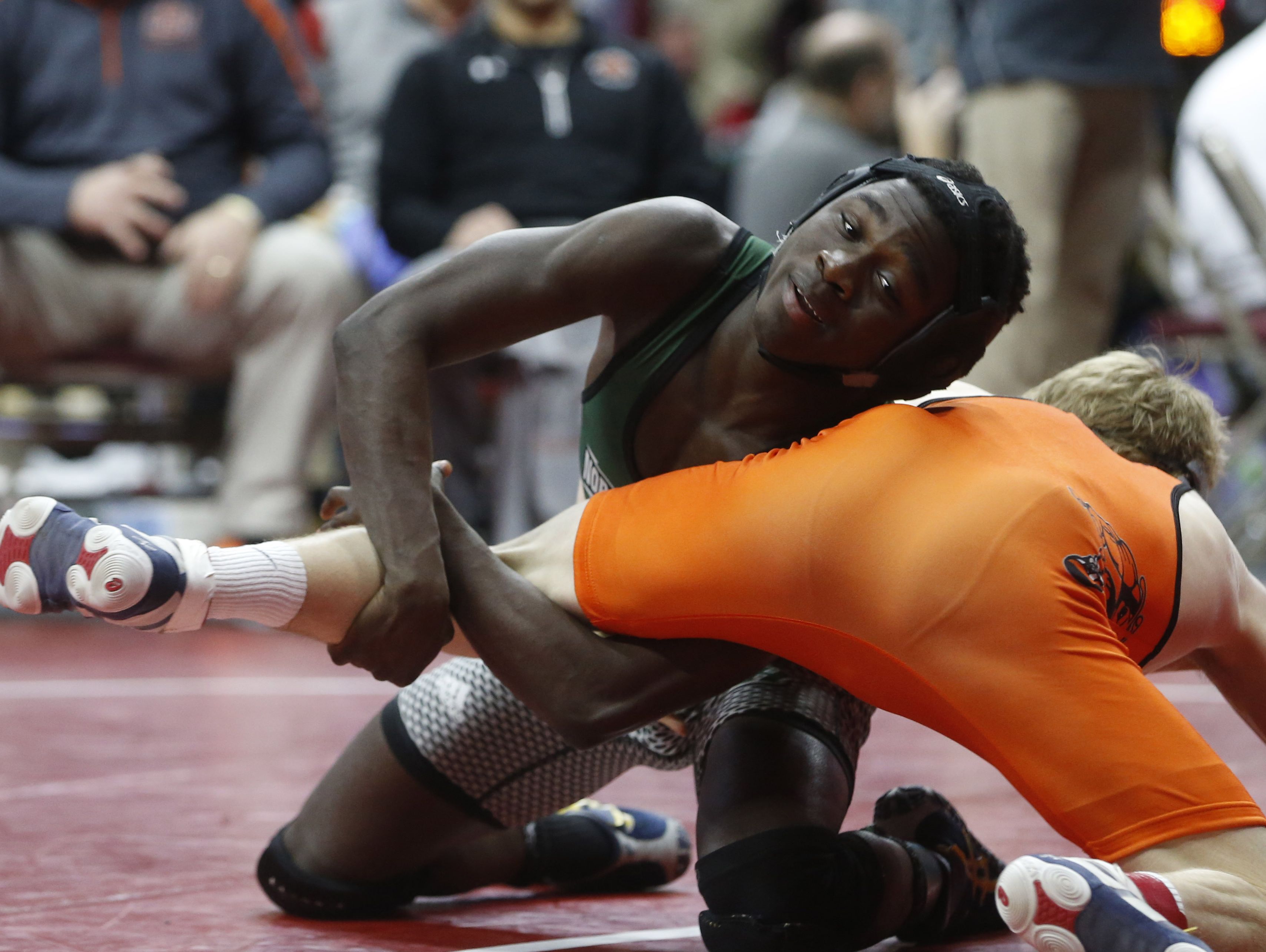 Shadrach Zarwie, left, of Des Moines North/Hoover wrestles Council Bluffs Thomas Jefferson's McGwire Midkiff in a Class 3A 126-pound match Thursday.
