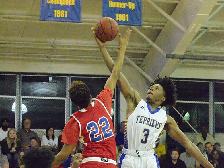 Kario Oquendo (3) wins the opening tipoff against Ony Guerrero (22) Thursday night as Titusville defeated Poinciana at home.