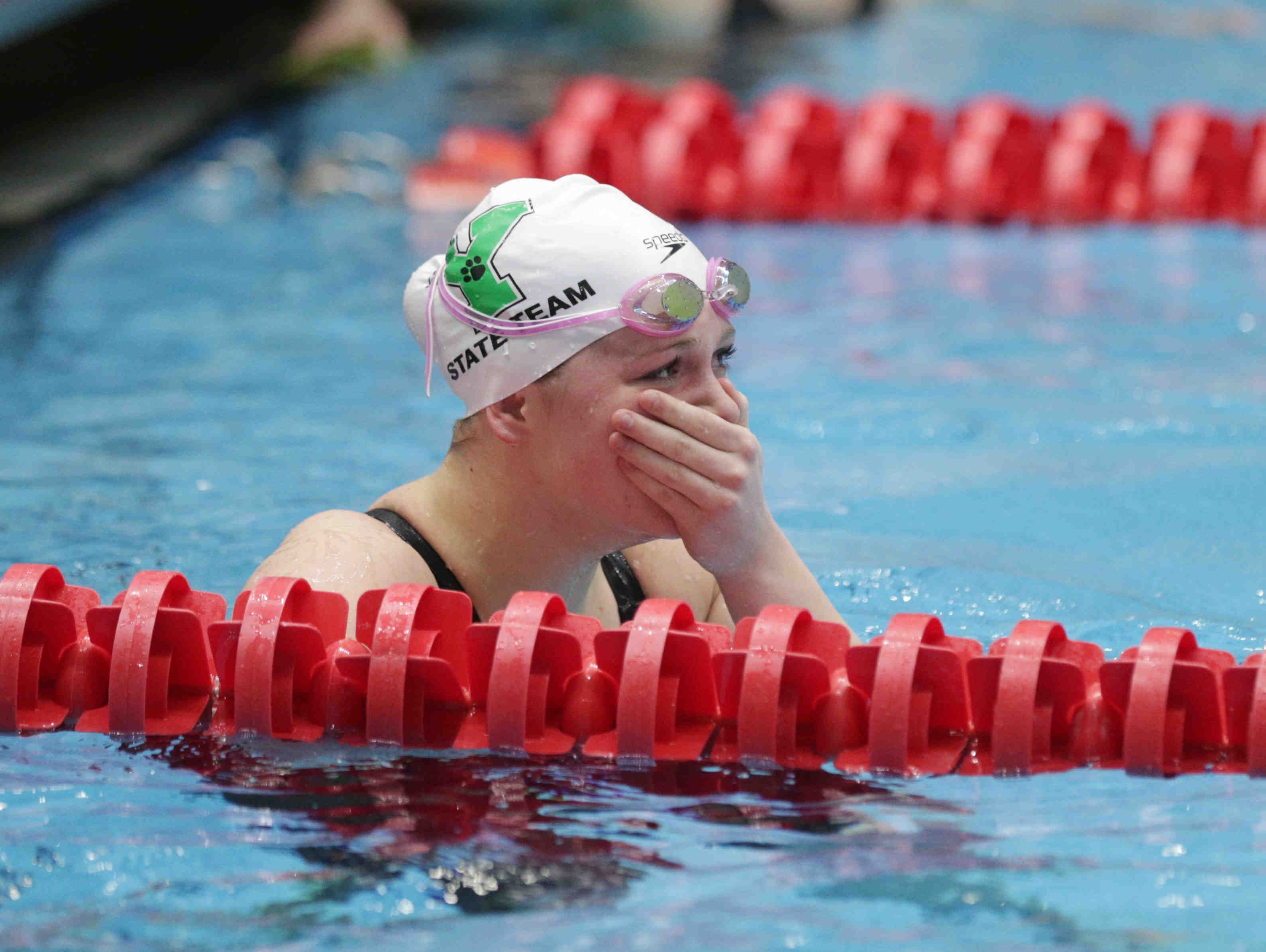 Yorktown's Emily Weiss looks at her time after completing the girls 100 yard breaststroke, during the IHSAA girls swimming state finals, held at IUPUI Natatorium, Feb. 11, 2017.