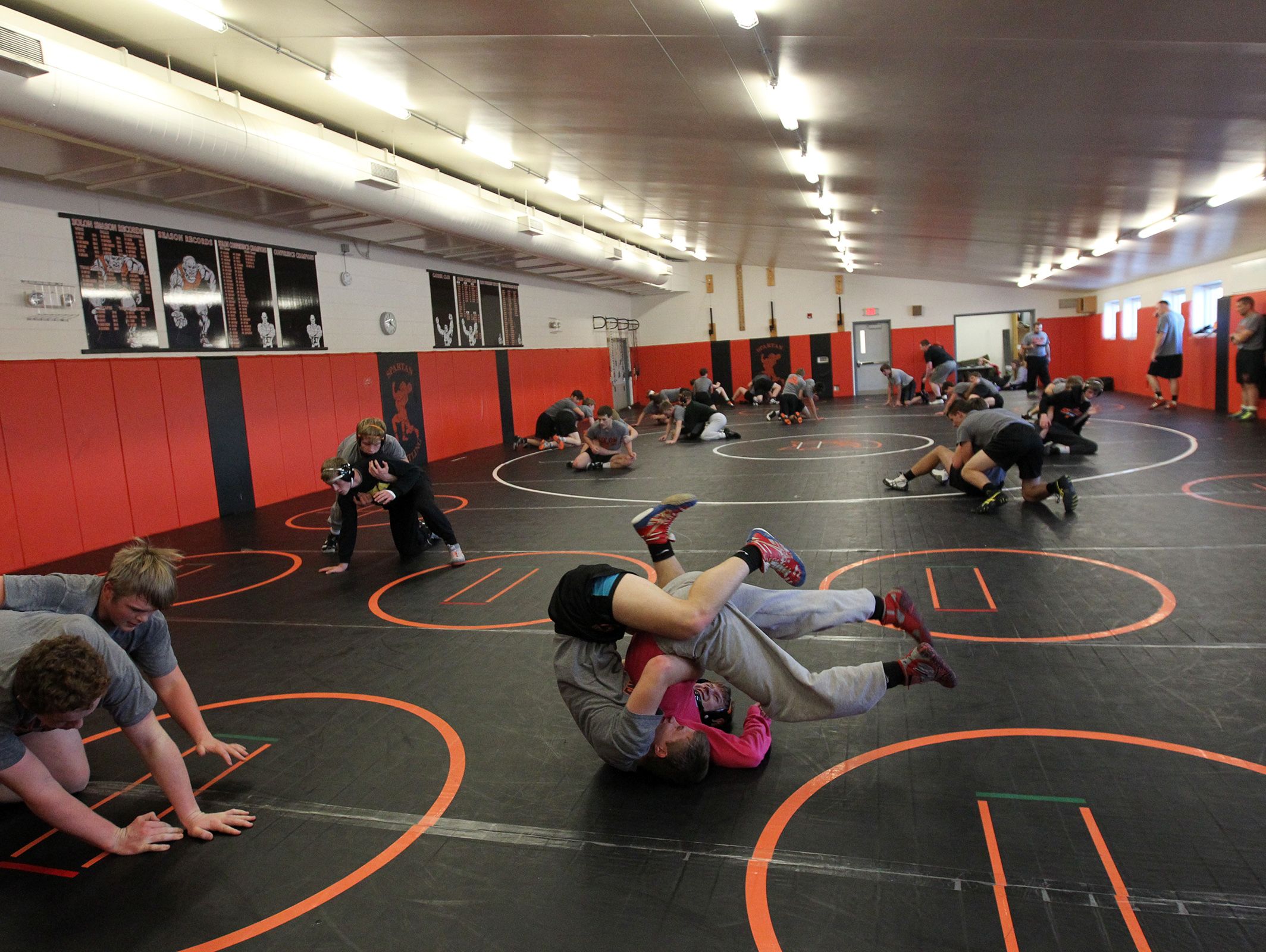 Solon's Drew West, middle left, wrestles his brother, Bryce, during practice on Tuesday, Dec. 13, 2016.