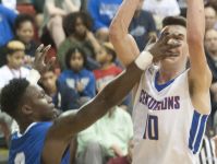Eastern guard Sugar Ray Wyche gets a hand in the face of the shooting Christian Academy of Louisville guard Parker Jones in the KHSAA 28th District Boys' Basketball Tournament. 21 February 2017