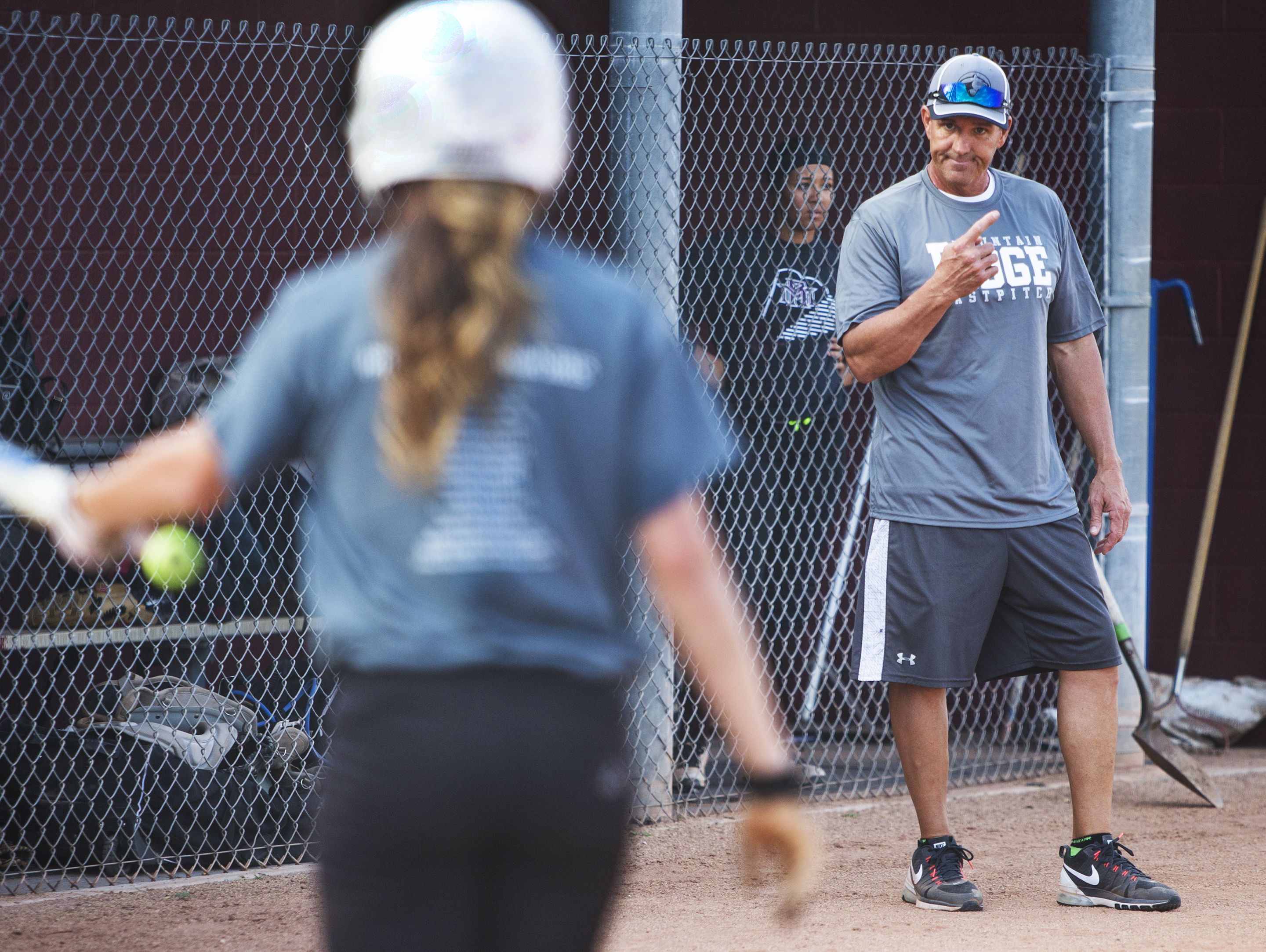 Kent Decker, the softball coach for Mountain Ridge High School in Glendale, got a lot of help and support from members of his team while battling throat cancer. He coaches the team, Monday, February 13, 2017.
