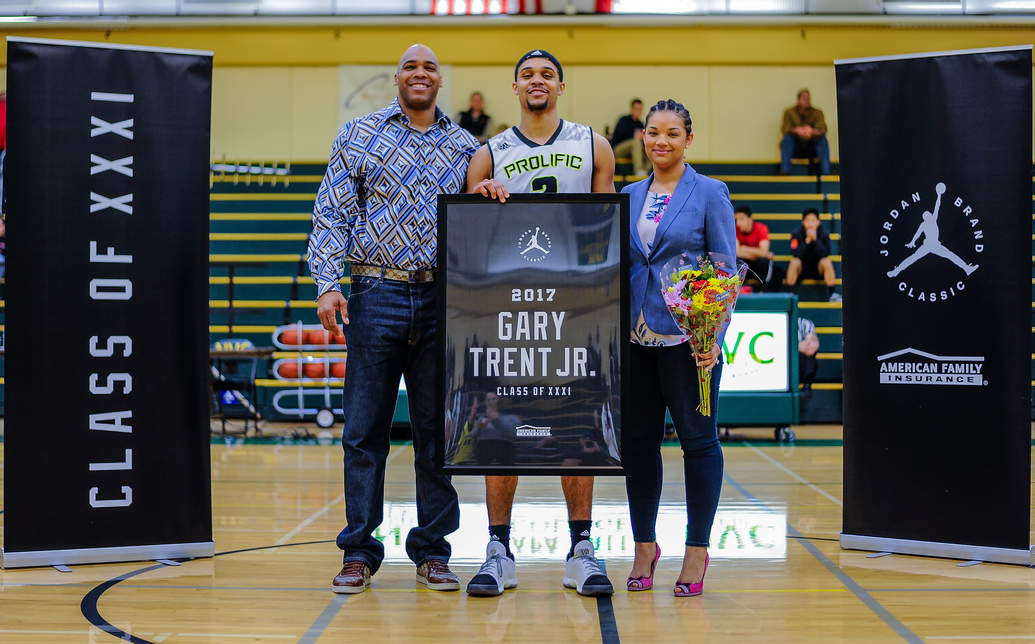 Gary Trent Jr. presented his mom and dad, Natalia and Gary Sr., with the Dream Champion Award. (Photo: Position Sports)