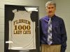 Florien's Dewain Strother poses with a jersey signifying his 1,000th career coaching victory.