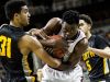 North Farmington defenders battle for a rebound with U-D Jesuit's Ikechukwu Eke, center, in a Class A boys high school basketball state championship game March 26, 2016, in East Lansing.