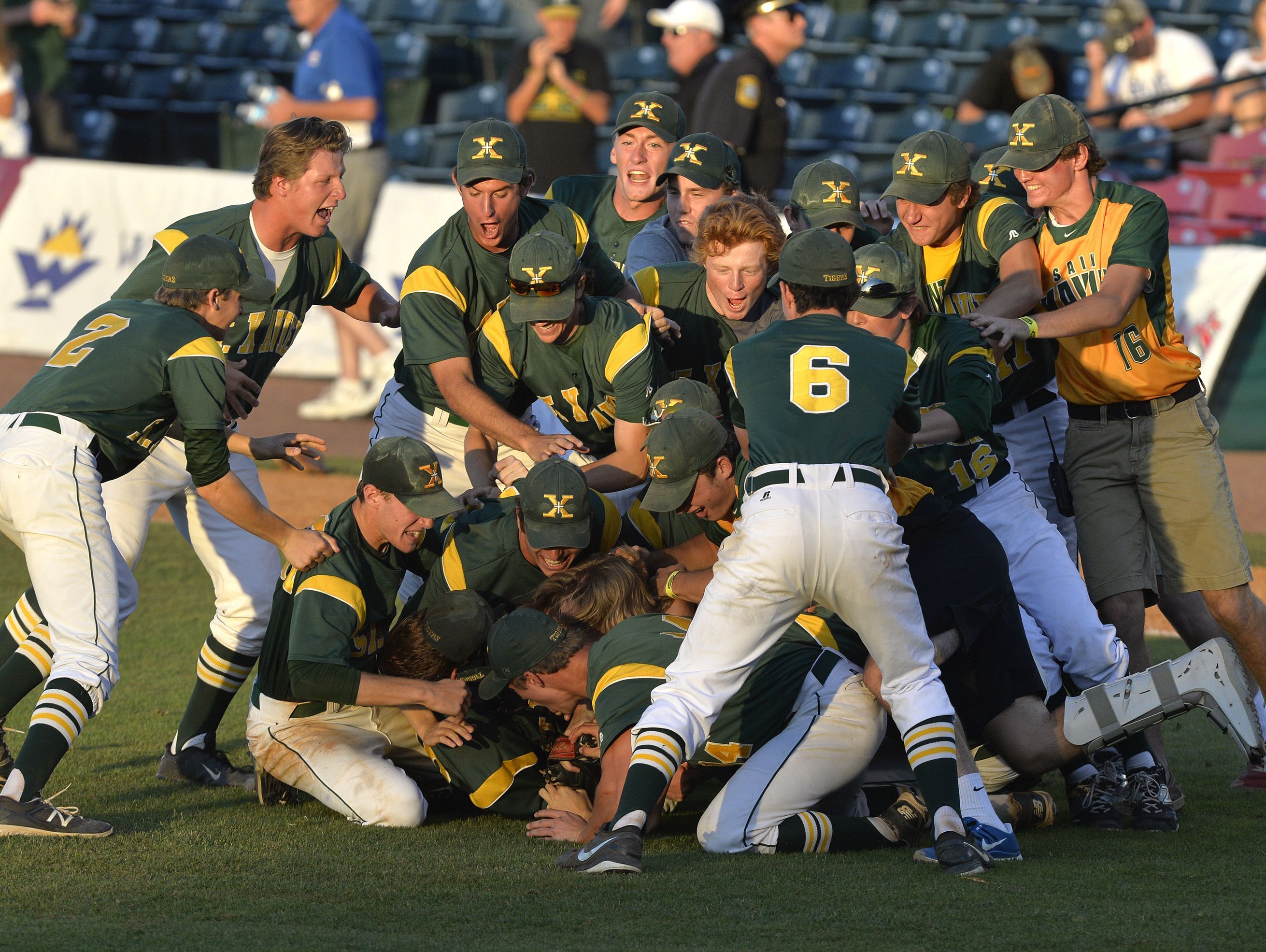 Members of the St. Xavier baseball team celebrate following their 1-0 victory in their Kentucky State baseball championship game Against Campbell County, Saturday, June 18, 2016 in Lexington Ky. (Timothy D. Easley/Special to the C-J)