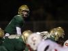 West High quarterback Evan Flitz waits for the snap during the Trojans' game against Ottumwa on Friday, Oct. 21, 2016.