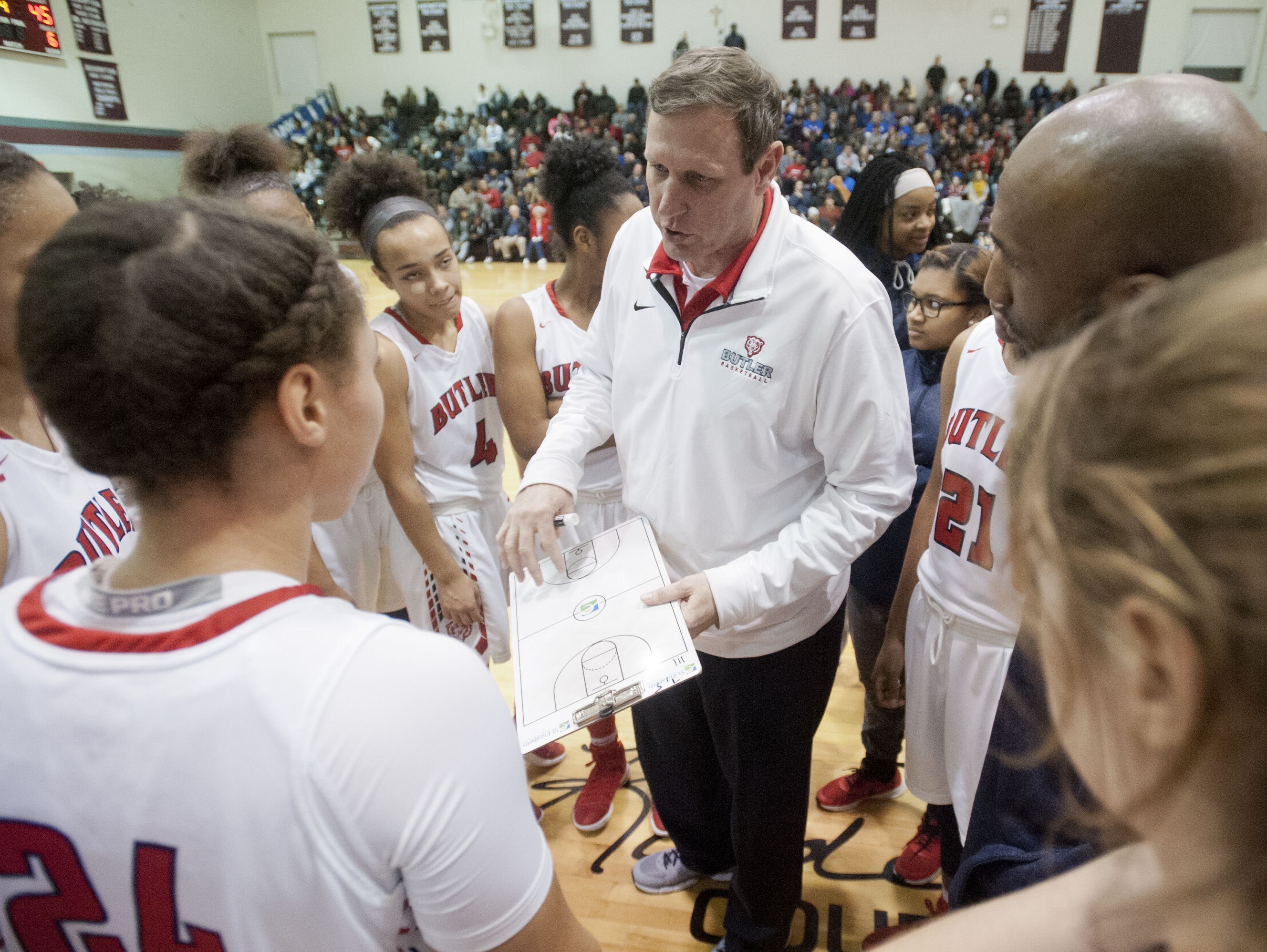 Butler head basketball coach Larry Just charts a play during a time-out in the Girls' LIT championship. 28 January 2017