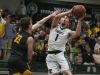 Trinity’s Jacob King (1) changes his shot to score against St. X’s Sam Boarman (33) during their game at Trinity High School. Feb. 28, 2017