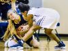 Brooke Rambo ,left, of Grand Ledge and Sanaya Gregory of East Lansing fight for a loose ball during their district semifinal game Wednesday March 1, 2017 at East Lansing High School. KEVIN W. FOWLER PHOTO