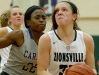 Zionsville Eagles Rachel McLimore (32) drives to the basket around Carmel Greyhounds Tomi Taiwo (22) in the first half of their game Tuesday, November 15, 2016, evening at Zionsville High School.