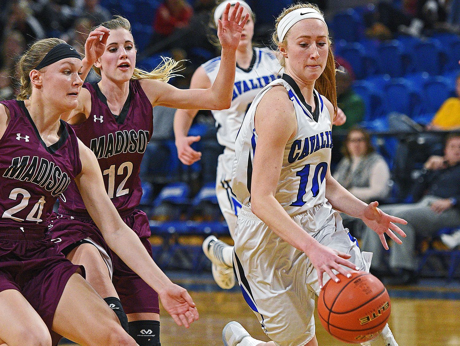 St. Thomas More's Dru Gylten (10) dribbles past Madison's Olivia Rud (24) and Jessi Giles (12) during a 2017 SDHSAA Class A State Girls Basketball Tournament quarterfinal game Thursday, March 9, 2017, at Frost Arena on the South Dakota State University campus in Brookings, S.D. St. Thomas More beat Madison 57-32.