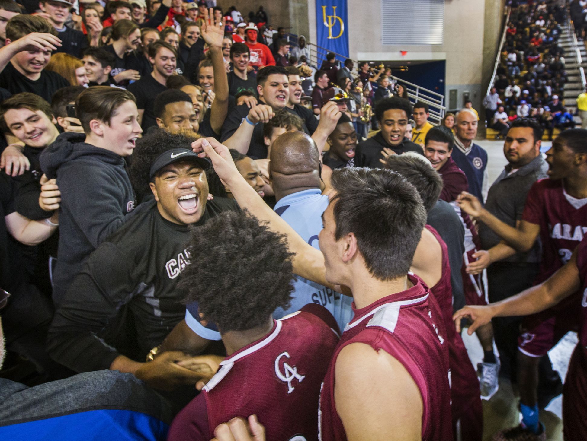 Caravel players and fans celebrate following their 48-47 win over St. Thomas More Academy in the DIAA Boy's State Basketball Tournament semi-finals at the Bob Carpenter Center in Newark on Thursday evening.
