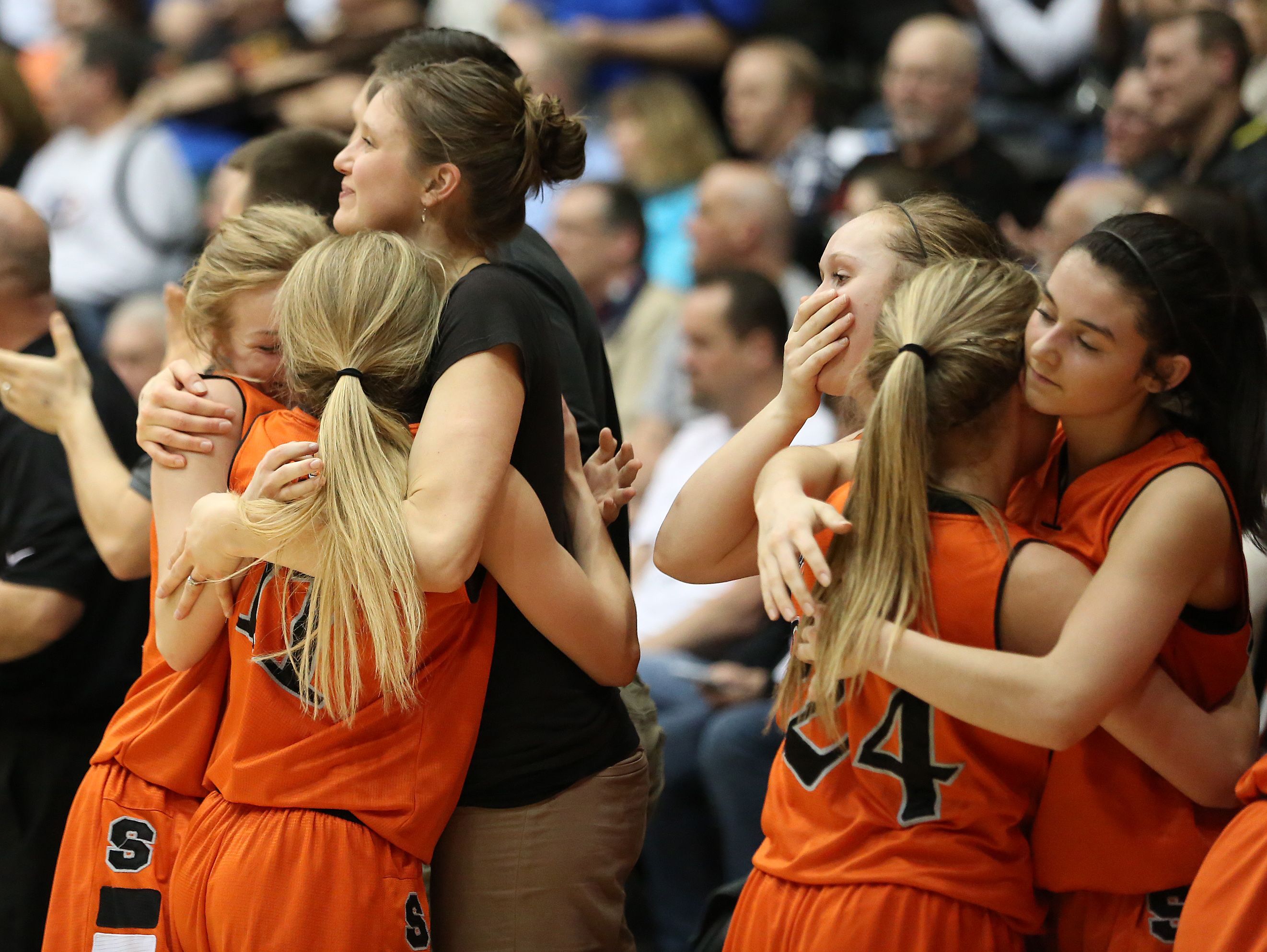 Silverton players embrace as the Foxes fall to LaSalle 42-28 in the OSAA Class 5A state championship on Friday, March 10, 2017, at Gill Coliseum in Corvallis.