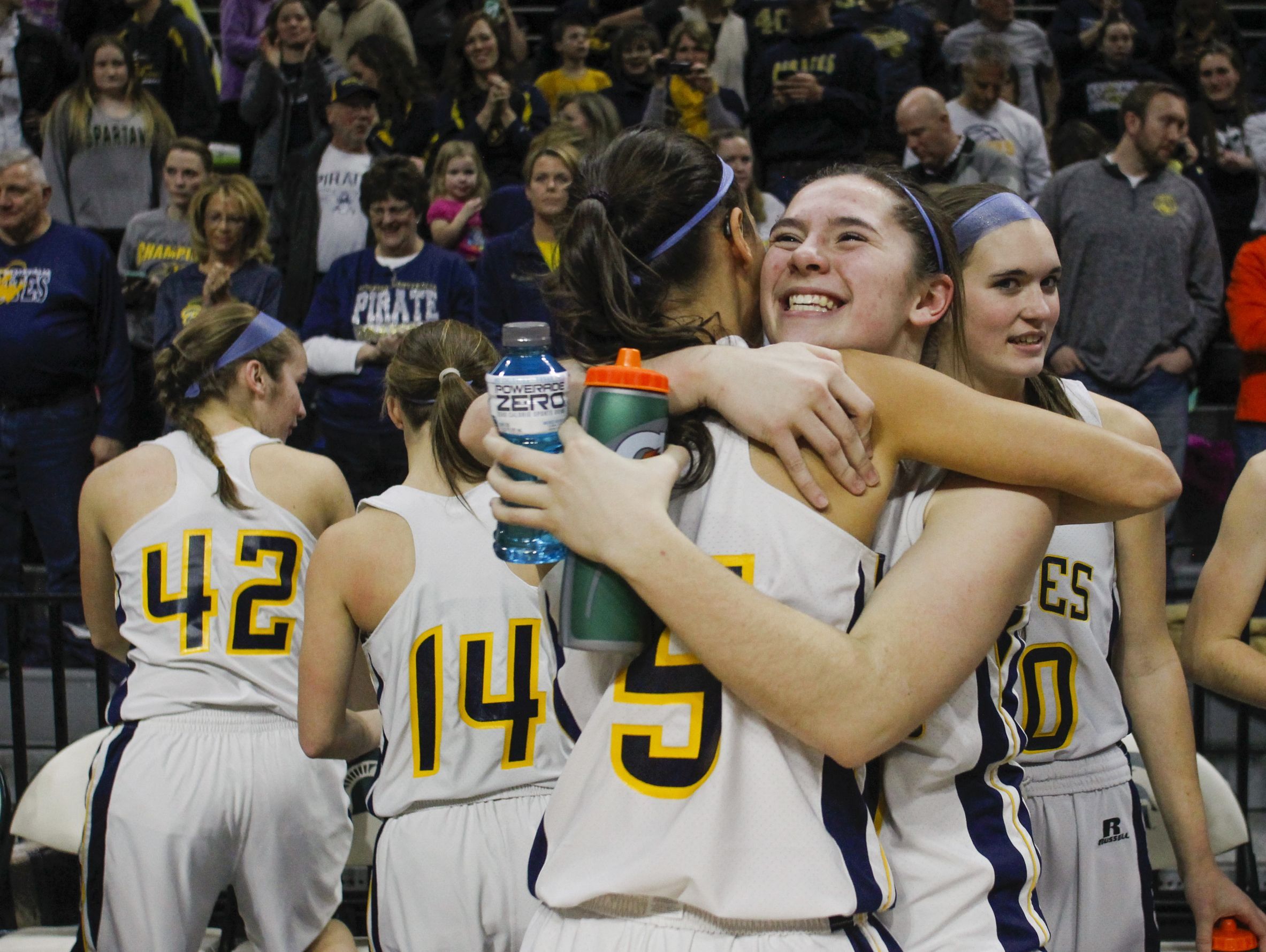 Pewamo-Westphalia 's Kylen Pohl hugs teammate Kiera Thelen, right, after the Pirates beat Maple City Glen Lake Thursday, March 16, 2017, during the Class B Semifinal at the Breslin in East Lansing. P-W won 64-51.