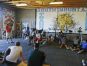 With trophies from his running days on a shelf in the background, South Mountain track coach Dwayne Evans talks to his athletes on March 21.