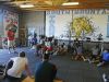 With trophies from his running days on a shelf in the background, South Mountain track coach Dwayne Evans talks to his athletes on March 21.