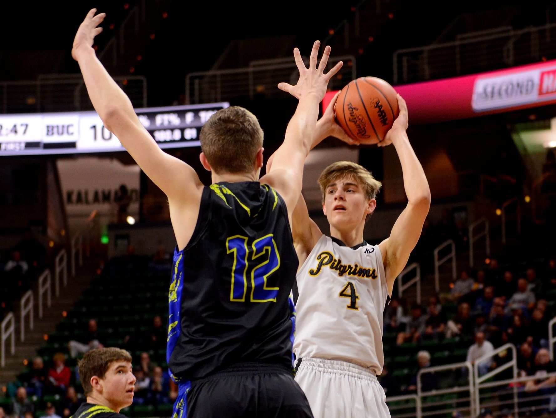 Lansing Christian's Kyle Lebeda looks to pass as Buckley's Austin Harris tries to block during the MHSAA state semifinal against Buckley on Thursday, March 23, 2017 at the Breslin Center in East Lansing.