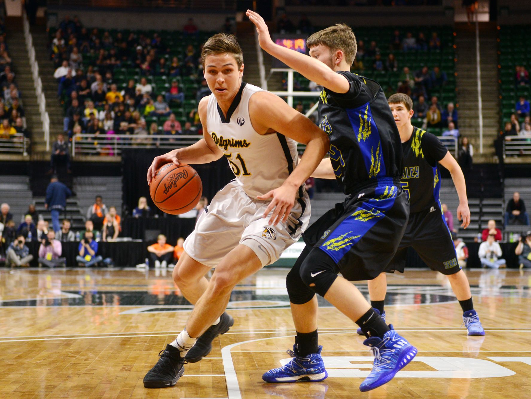Lansing Christian's Preston Granger tries to dribble past Buckley's Brock Beeman during the state semifinal against Buckley on Thursday, March 23, 2017 at the Breslin Center in East Lansing.