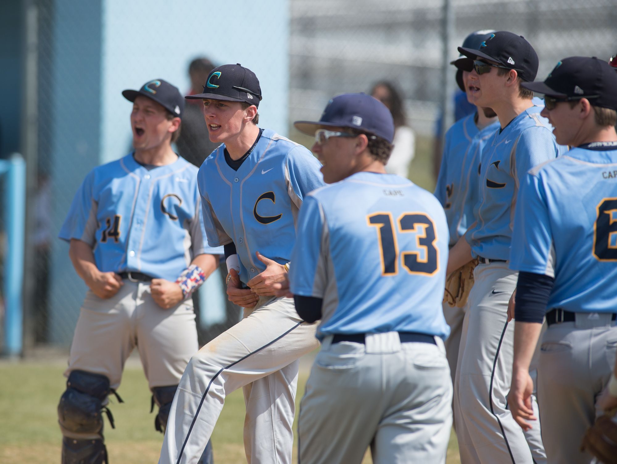 Cape Henlopen's team celebrates at home plate after Zachary Dale (10) hit a home run in their home game against Caravel.