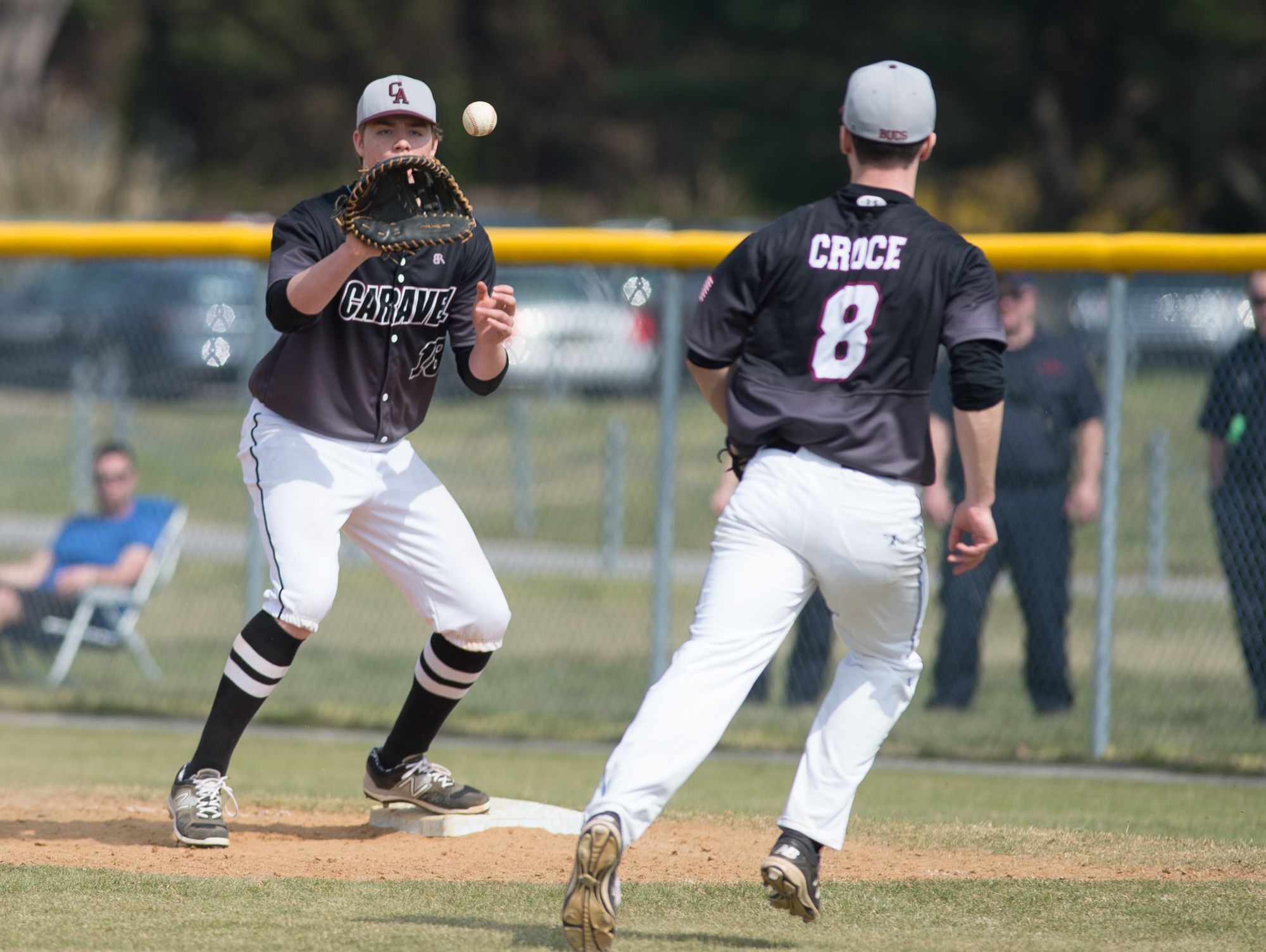 Caravel’s Tyler Croce (8) throws the ball to teammate Cole Reynolds (18) for the final out in their 11-10 win over Cape Henlopen.