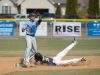 Caravel’s Ethan deRegis (9) slides into second base as the ball is thrown to Cape Henlopen’s Dwayne Harmon (13).
