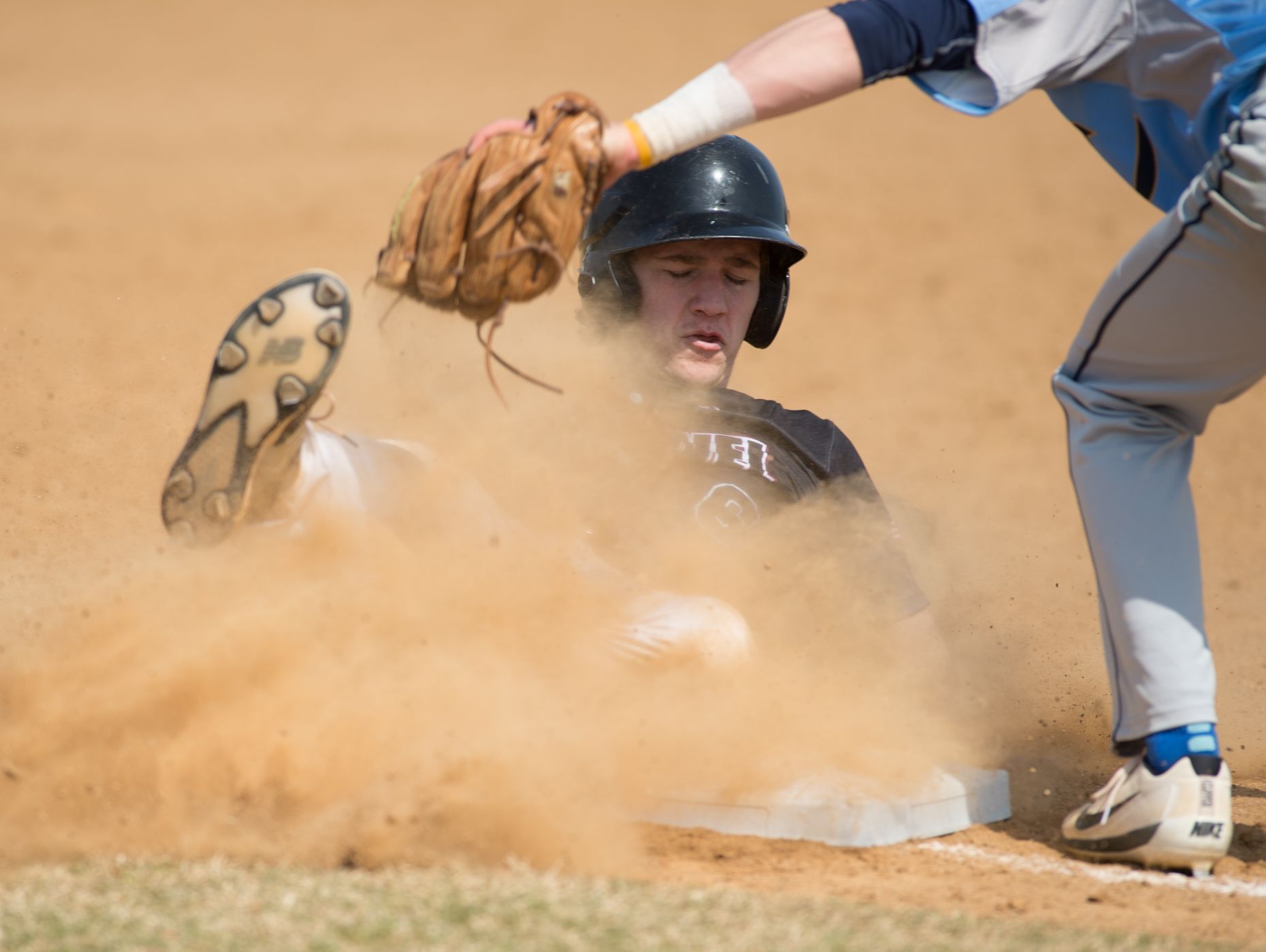 Caravel’s Joey Silan (6) slides safety into third base in their 11-10 win over Cape Henlopen.