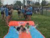 Members of the Airline softball team slip and slide with Emilie Gibson Monday afternoon.