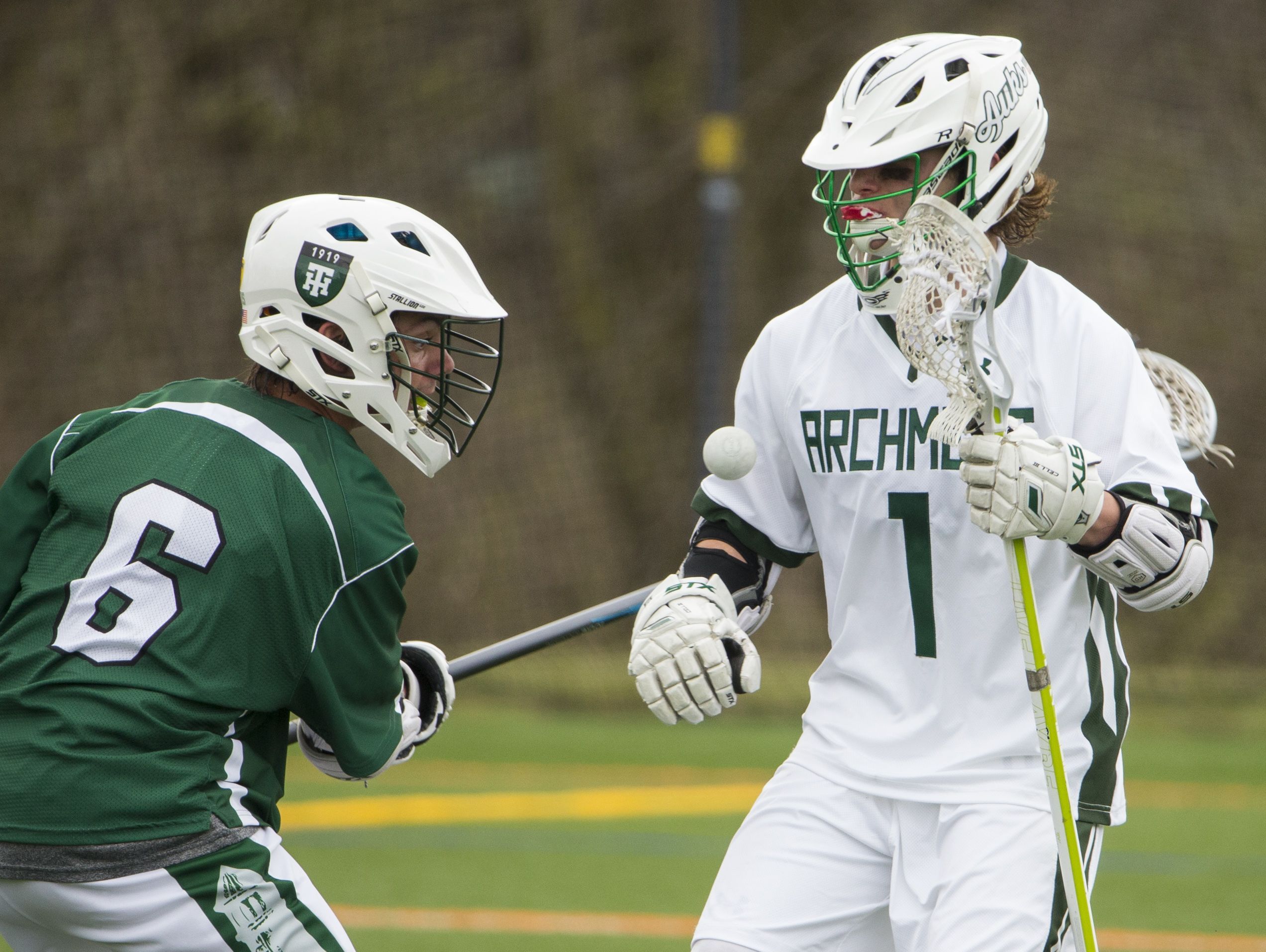 Tower Hill's Sylvester Schorn (left) moves for a loose ball against Archmere's Cole Bauer in the second half of Archmere's 12-7 win Saturday.