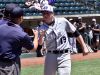 CHCA starting Pitcher Griffan Smith greets the umpire crew at home plate during team introductions.
